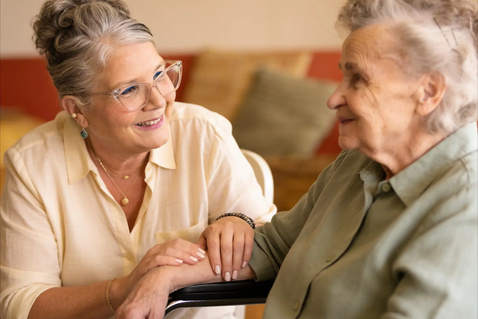 Tammy Rumberger, RN, sitting with a client, hands resting on her arm in conversation